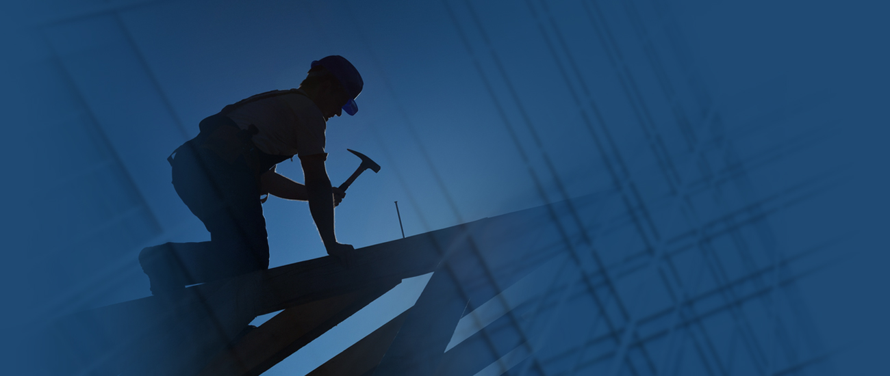 Worker hammering a long nail.